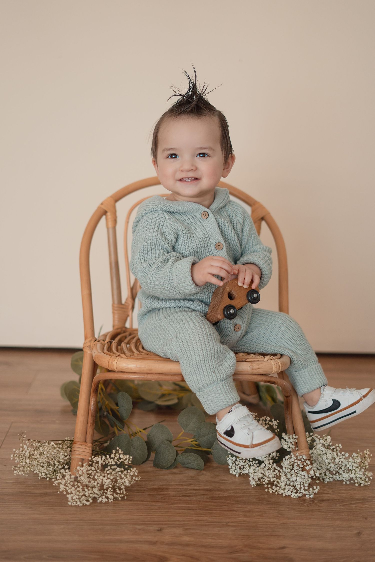 Energetic one-year-old boy photoshoot in Grand Rapids, capturing a happy baby's personality during a milestone photography session.