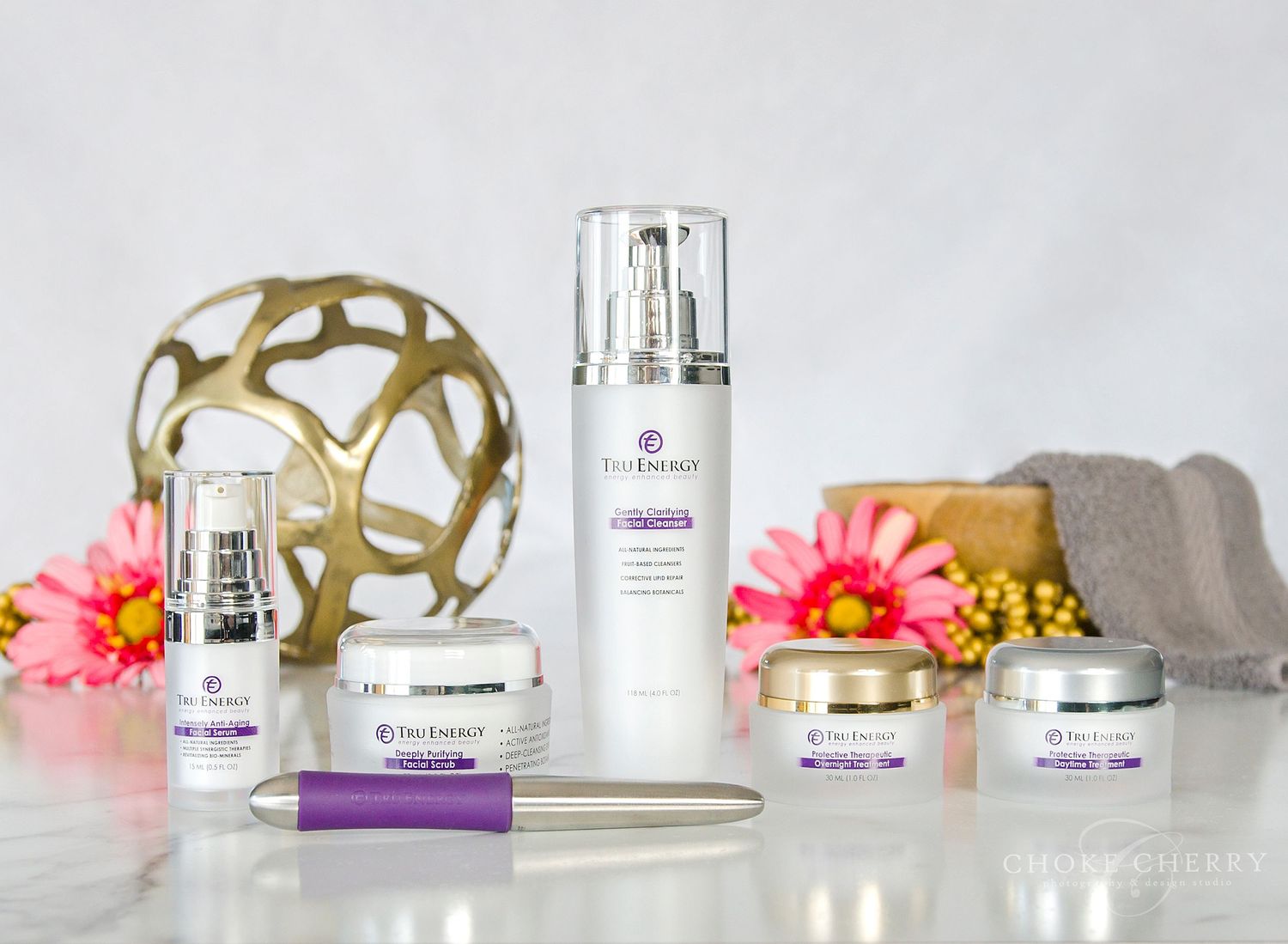 Product photography of high-end luxury skin care line bottles and face wand