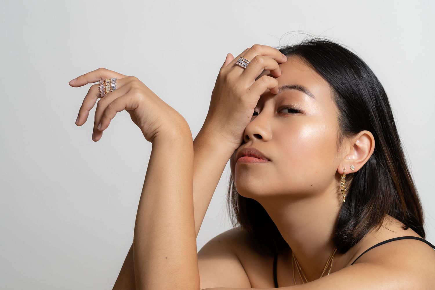 Artistic beauty portrait showing elegant pose with natural makeup against grey background.