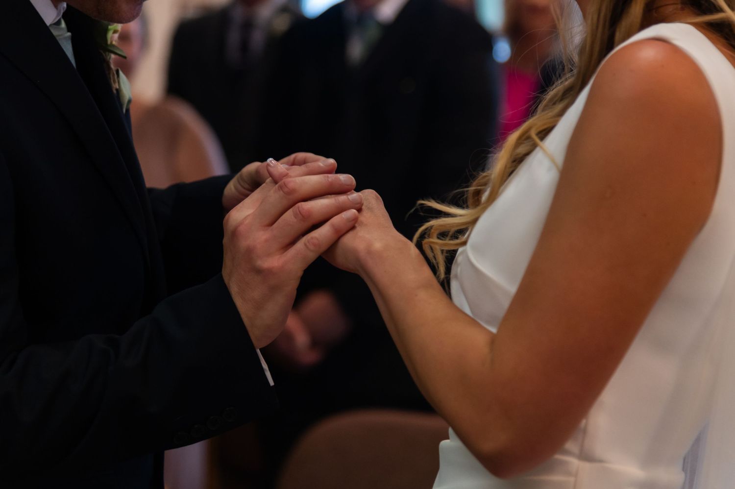 Wedding guests share an intimate moment during a reception indoors.