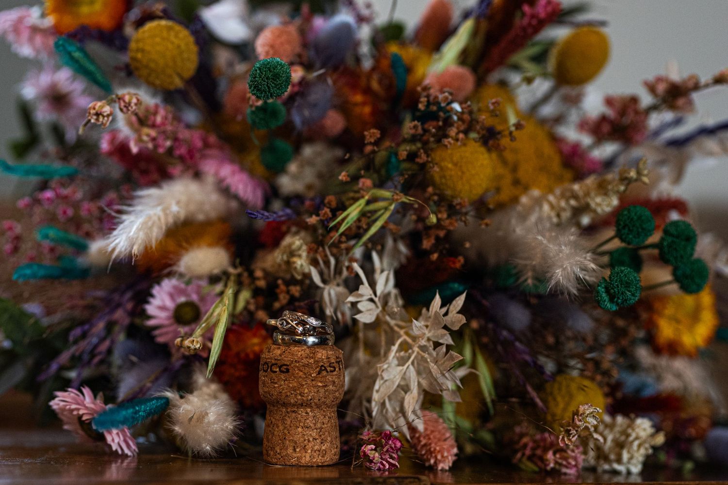 Colorful dried flower arrangements displayed at wedding reception.