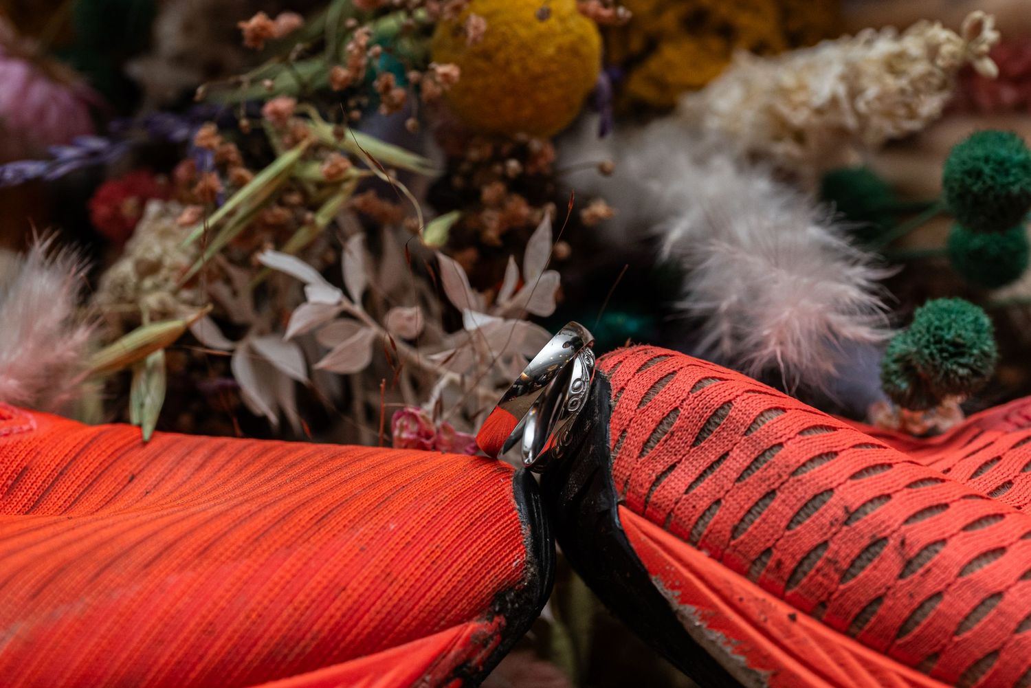 Decorative red textured fabric with natural elements creates elegant wedding decor.