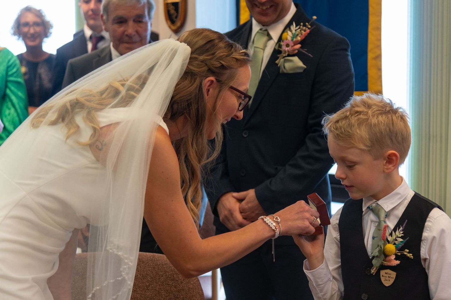 Wedding ceremony moments captured indoors with warm natural lighting.