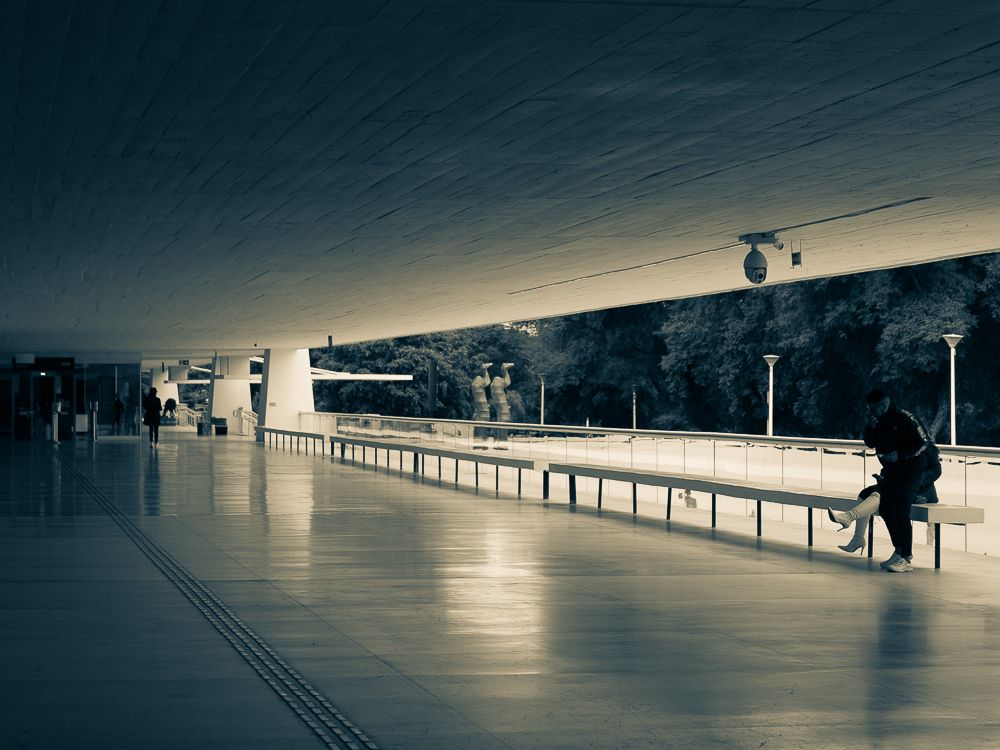 Minimalist architectural corridor with reflective floor and strong perspective.
