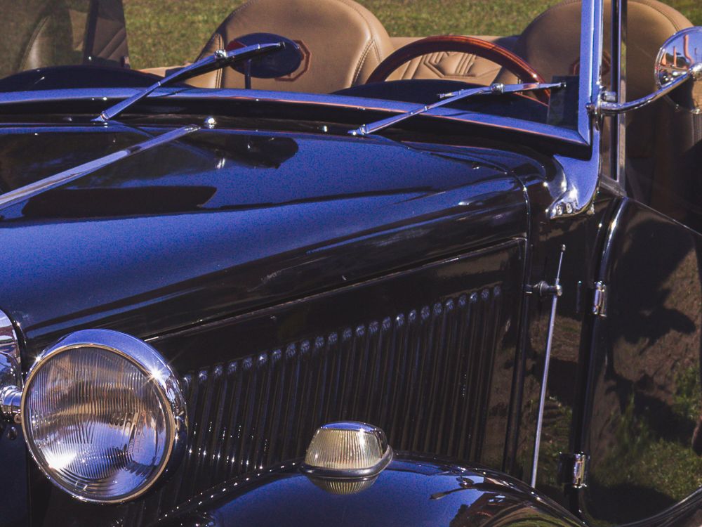 Close-up of vintage blue car headlight and chrome detail, photographed by Piret Victoria Ribas.