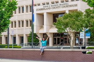 A celebratory pose in front of Cumberland County Courthouse on a sunny day.
