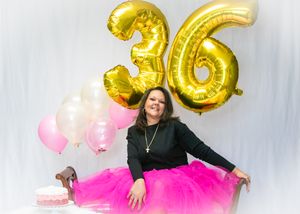 Celebratory photo shoot with pink tulle skirt and gold number 36 balloon decorations.