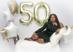 Festive 50th birthday photoshoot setup with gold and silver balloon numbers and white star balloons against white background.