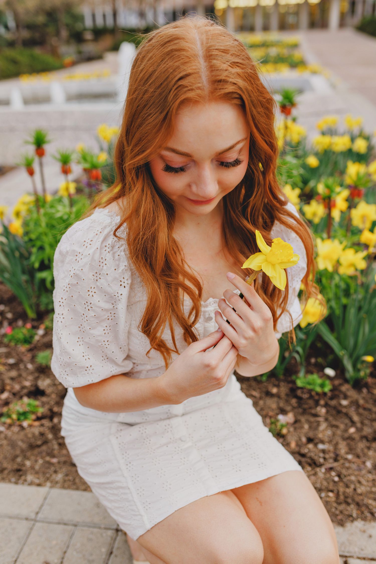 Wedding guests attending outdoor ceremony with colorful attire.