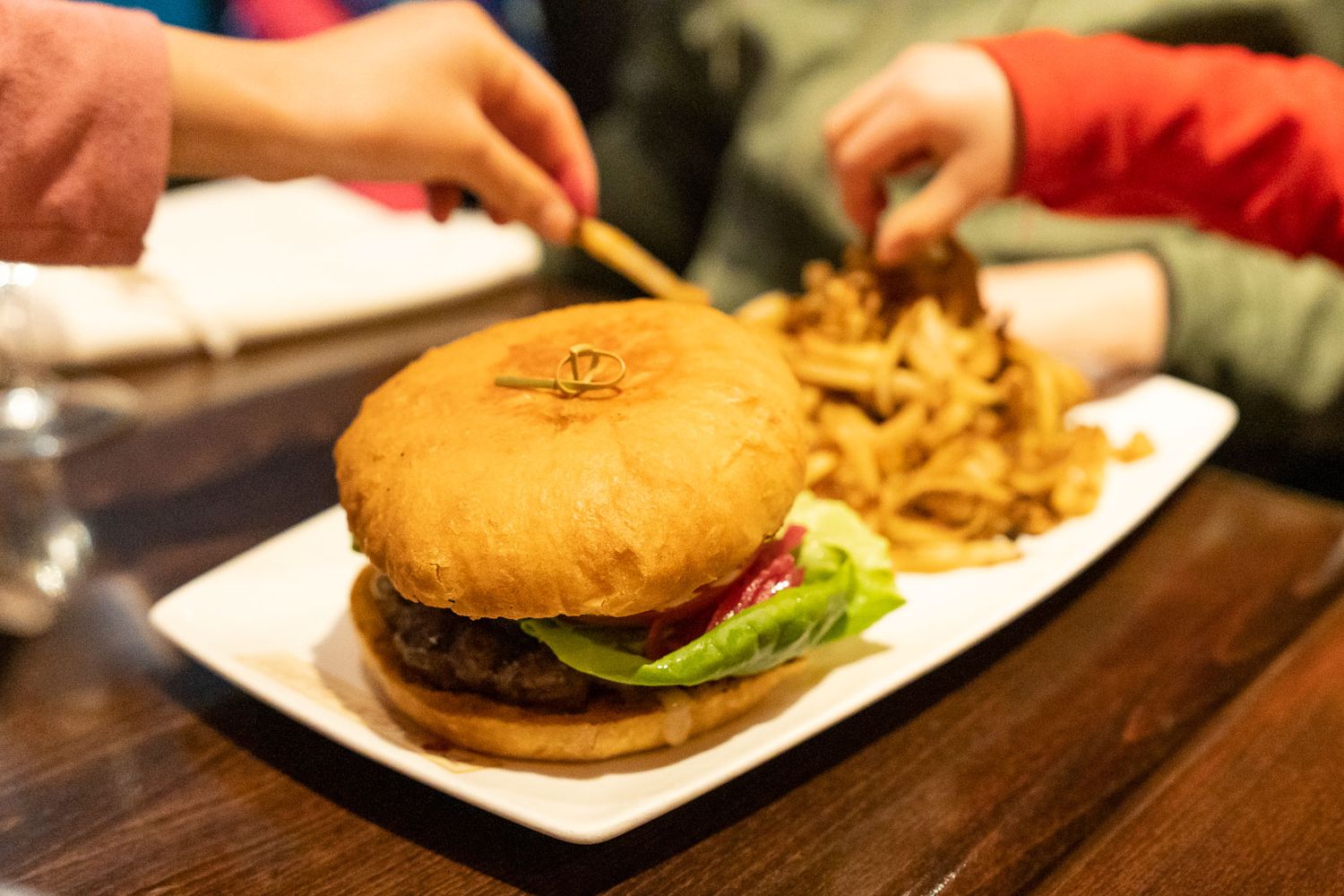 Kids eating burger and fries at Pomegranate Bistro in Redmond.