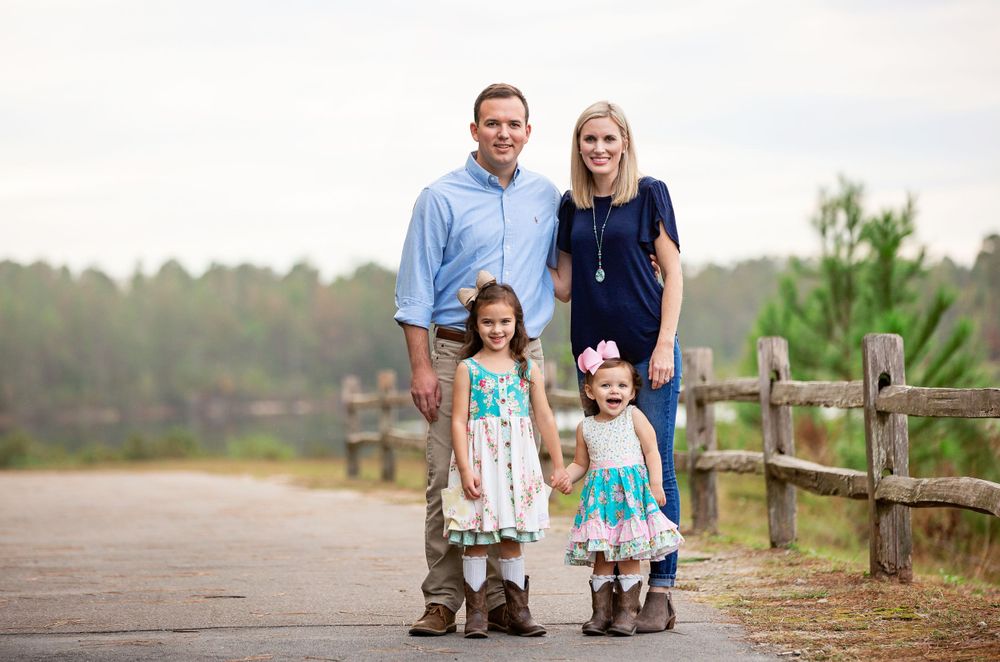 A collection of candid family portraits taken outdoors with rustic wooden fencing in the background.
