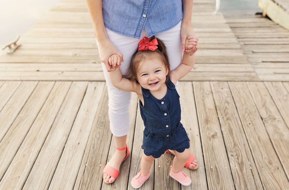 Casual family moments captured on a wooden deck wearing coordinated blue and white outfits.