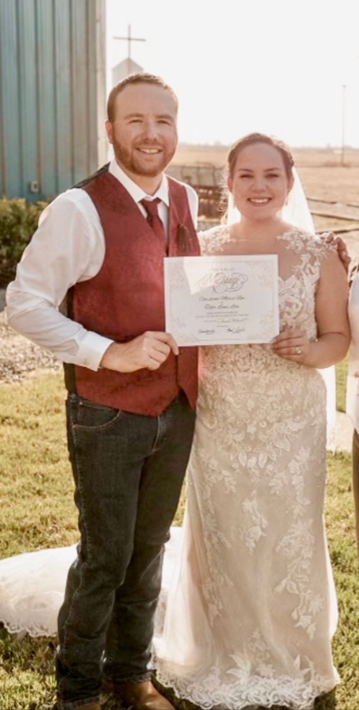 A joyful bride and groom pose with their officiant , capturing a beautiful moment on their wedding day.