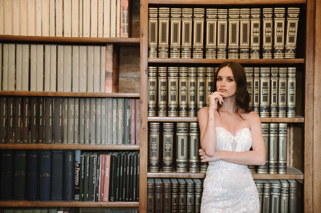 Classic library interior with floor to ceiling bookshelves filled with vintage volumes.