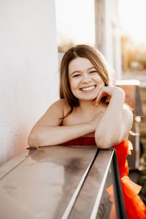 Candid portrait series showing genuine smiles and relaxed poses against a white wall.