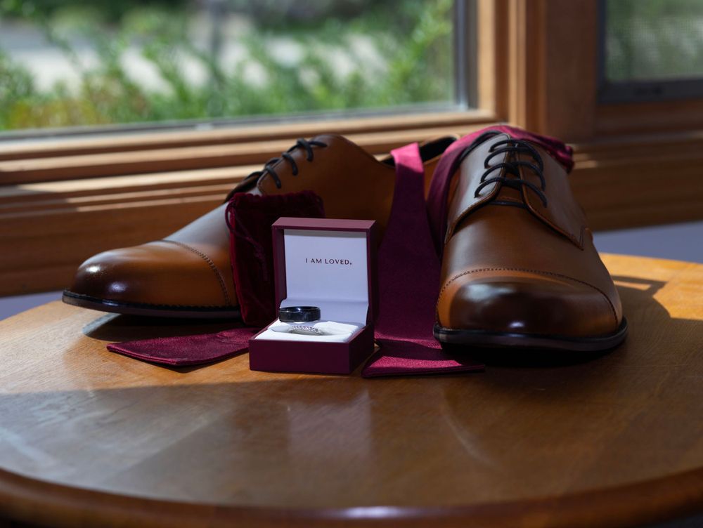 wedding detail shot of grooms shoes and accessories