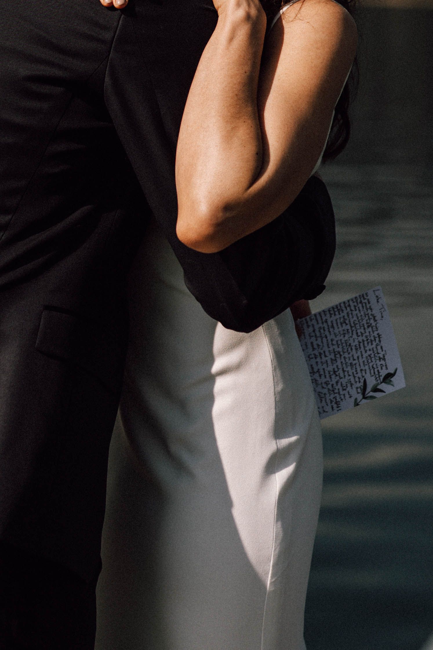 Abstract close-up details of formal black and white wedding attire.