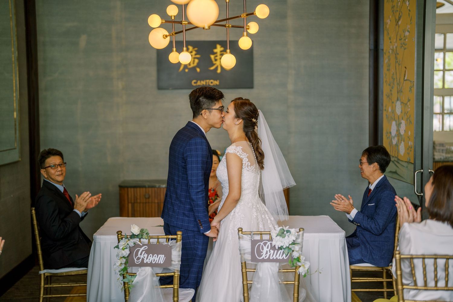 Wedding reception hall with elegant lighting and table decorations.