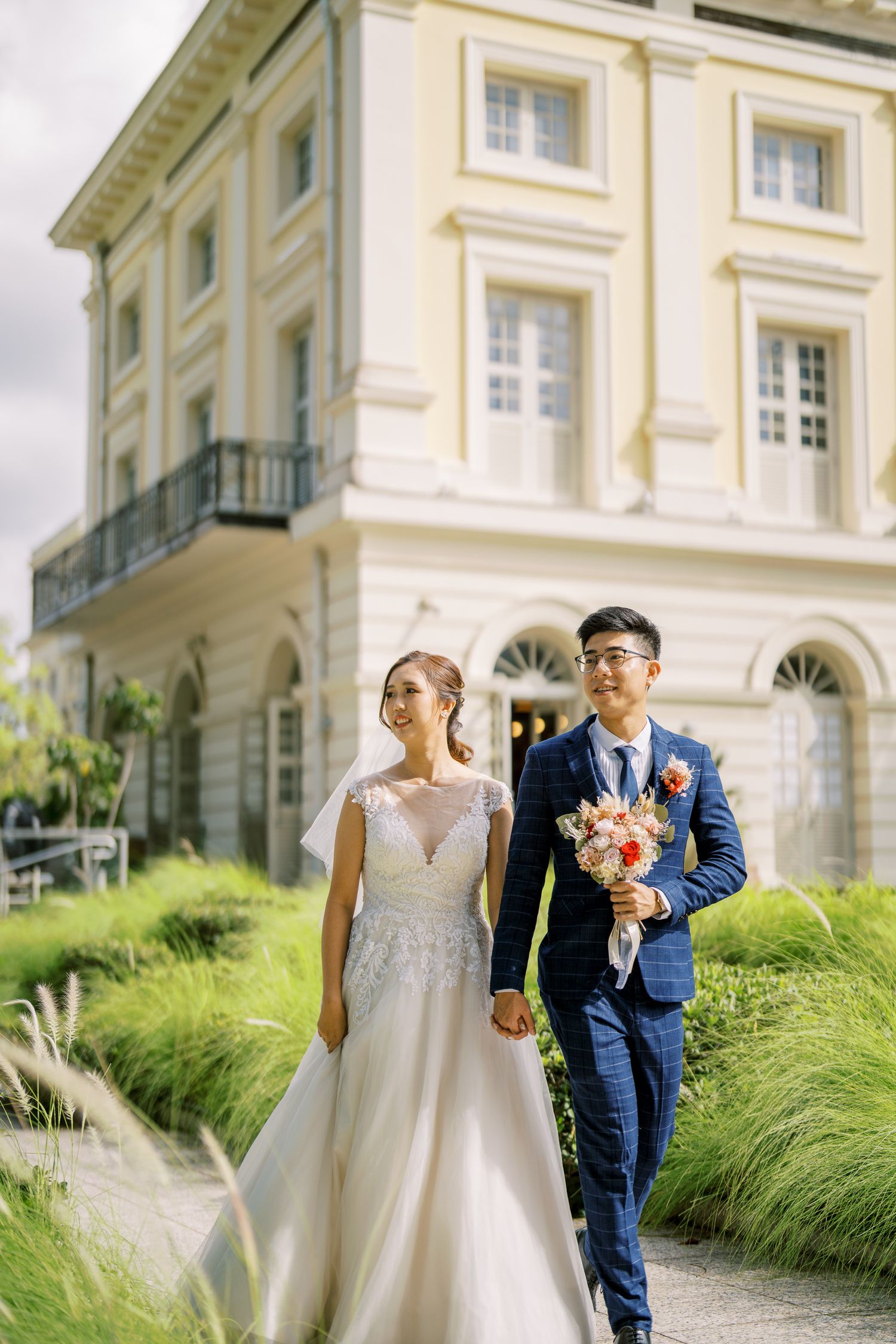 Classic cream-colored building exterior with ornate architectural details and landscaping.