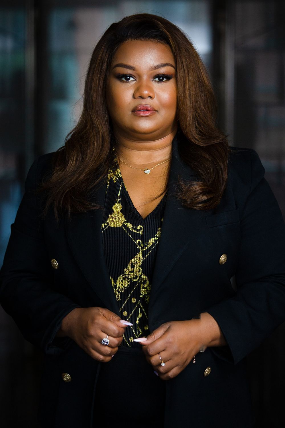 Elegant black blazer with gold embroidered details shown in a professional photoshoot in Nairobi Kenya