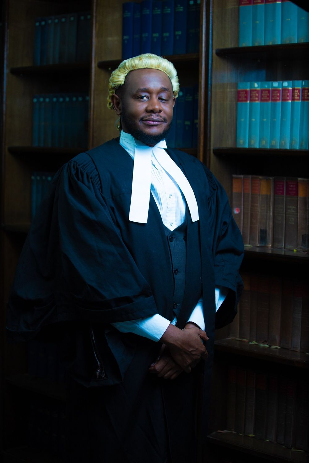 Legal professional wearing traditional black barrister robe and wig in a law library  in Nairobi Kenya