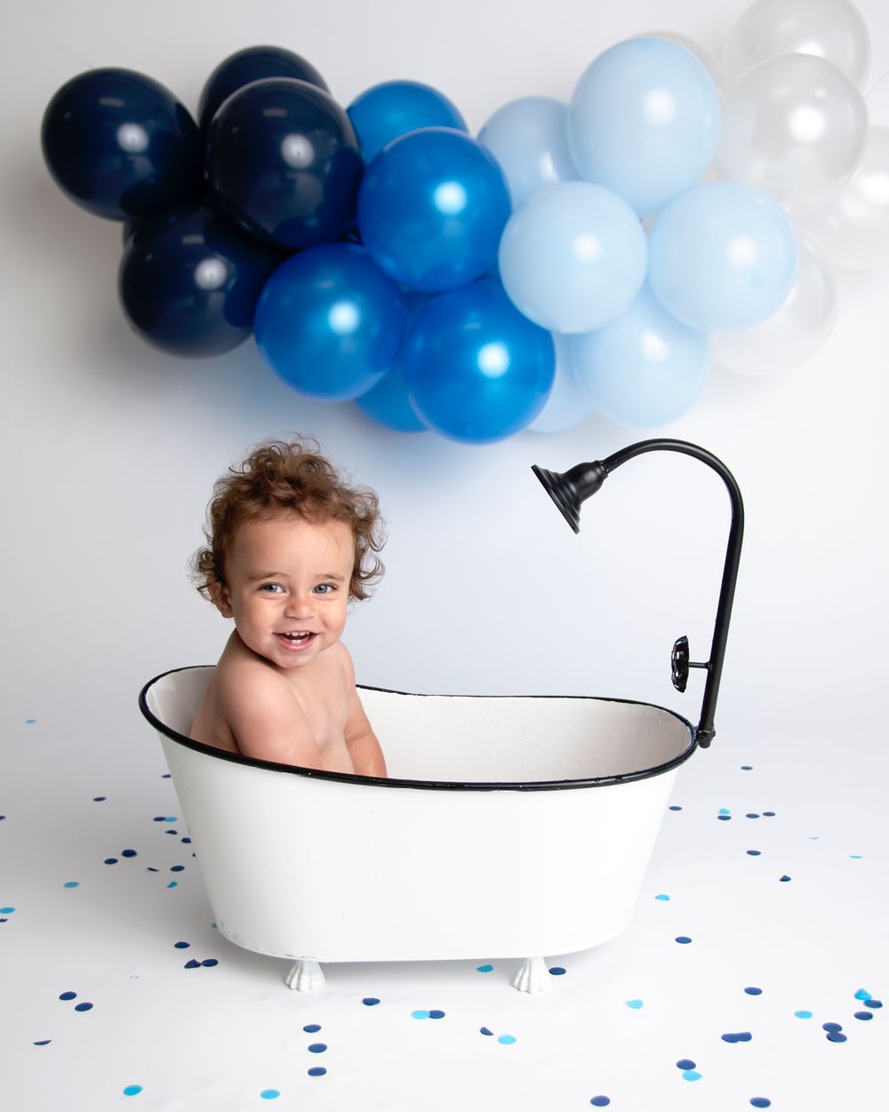 Cleveland Ohio Family Cutest Bath tub clean up after one year cake smash session Ohio