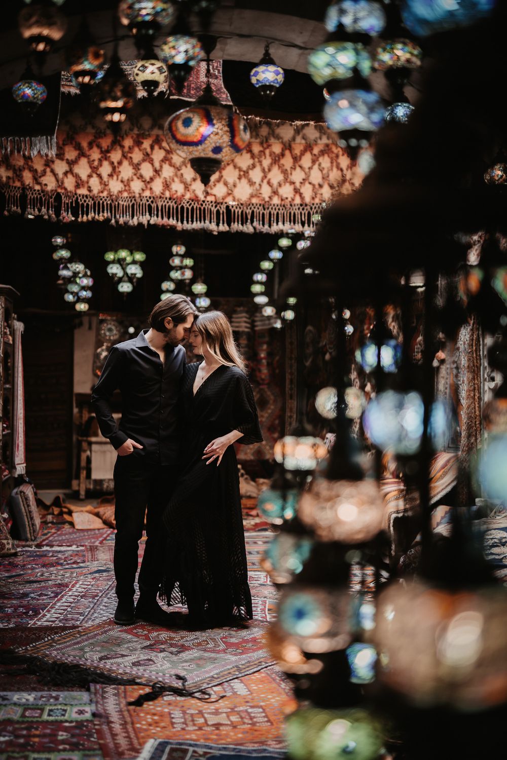 A romantic moment under ornate Turkish lanterns and decorative lighting.