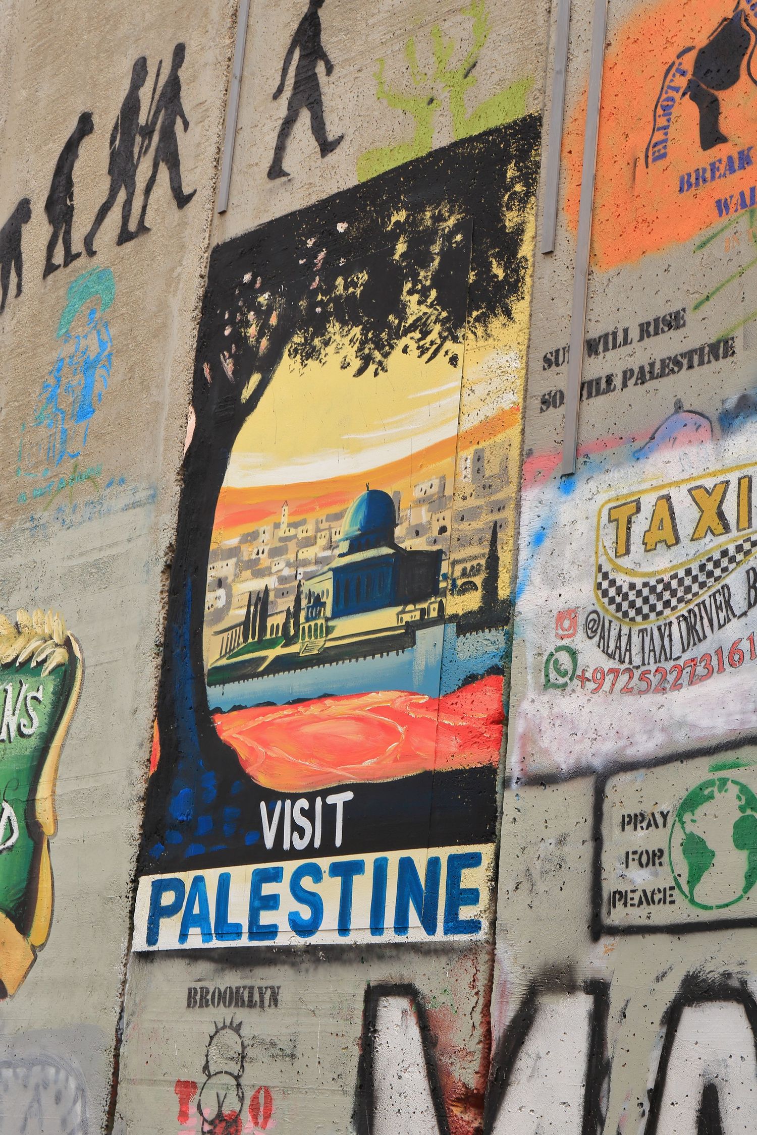Tourism promotion art on concrete wall shows Visit Palestine poster with silhouettes and scenery.