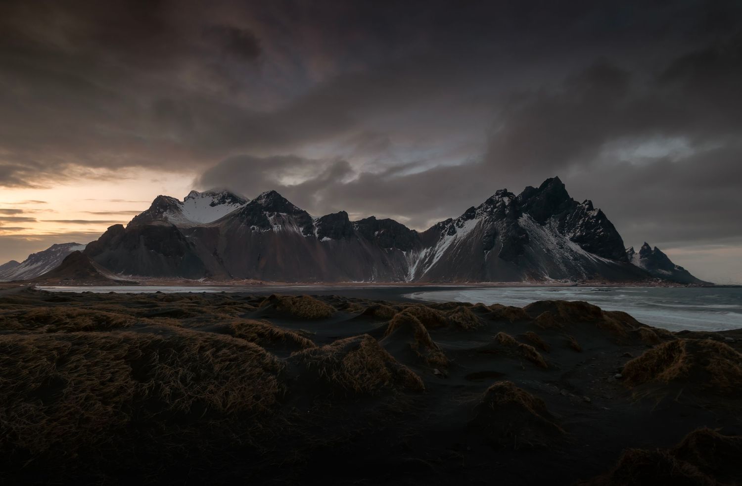 Dramatic mountain landscape with stormy clouds at Vestrahorn, Iceland.