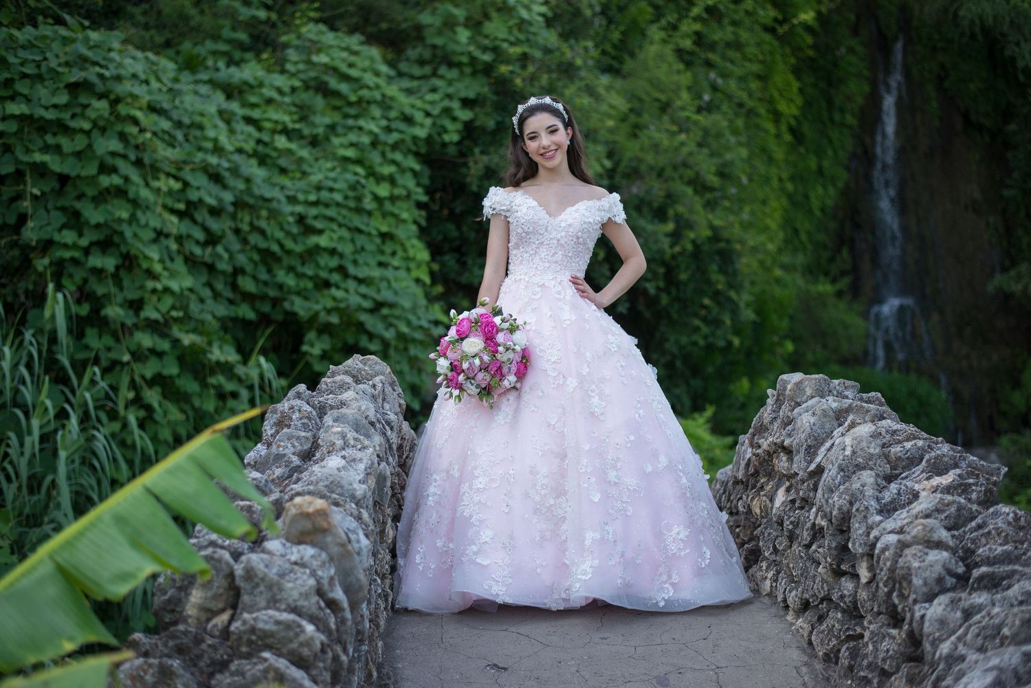 Elegant bridal portraits on rustic stone steps surrounded by greenery.