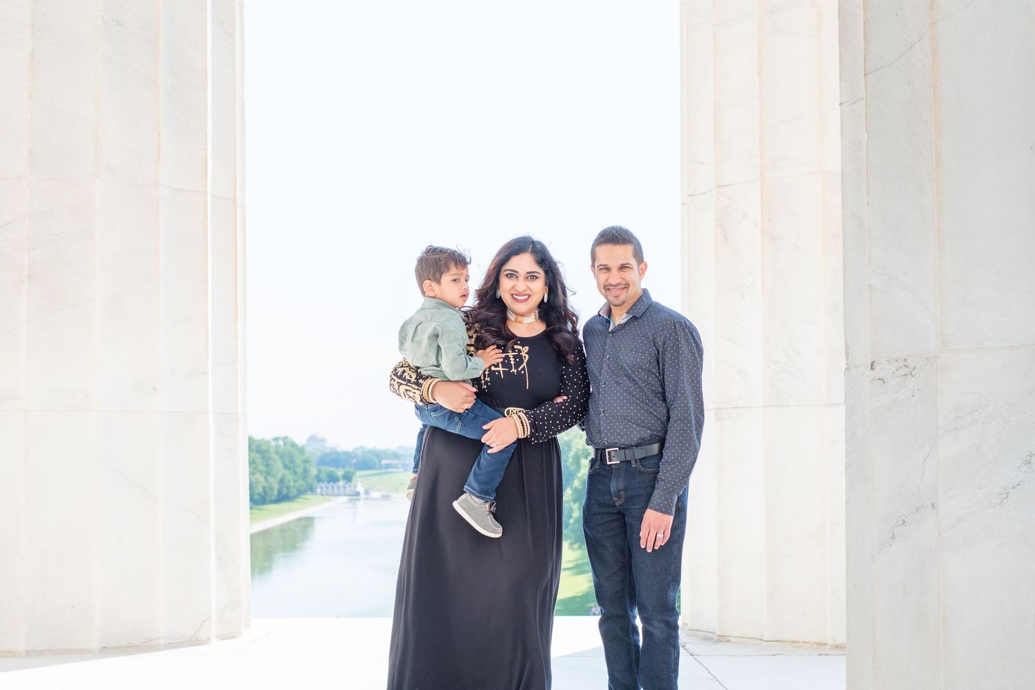 mom, dad, and son in front of Lincoln Memorial columns