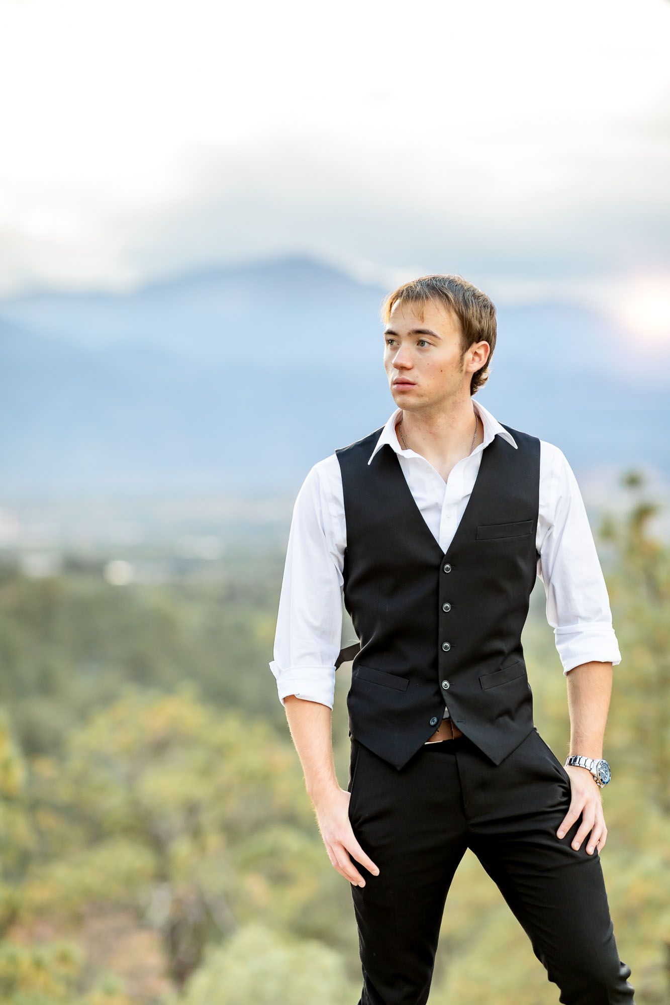 Senior guy poses with hands in pockets at his senior session at Palmer Park in Colorado Springs.