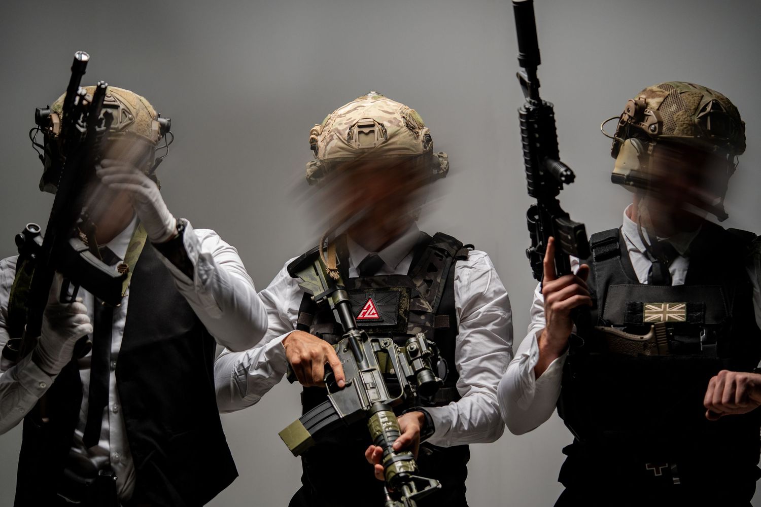 Tactical team members in protective gear holding rifles during a training exercise.