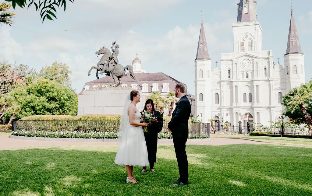 A couple reads their vows to each other while their officiant leads them with a script.