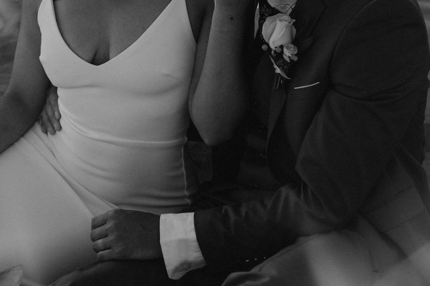 Intimate black and white close-up shot of a couple embracing.