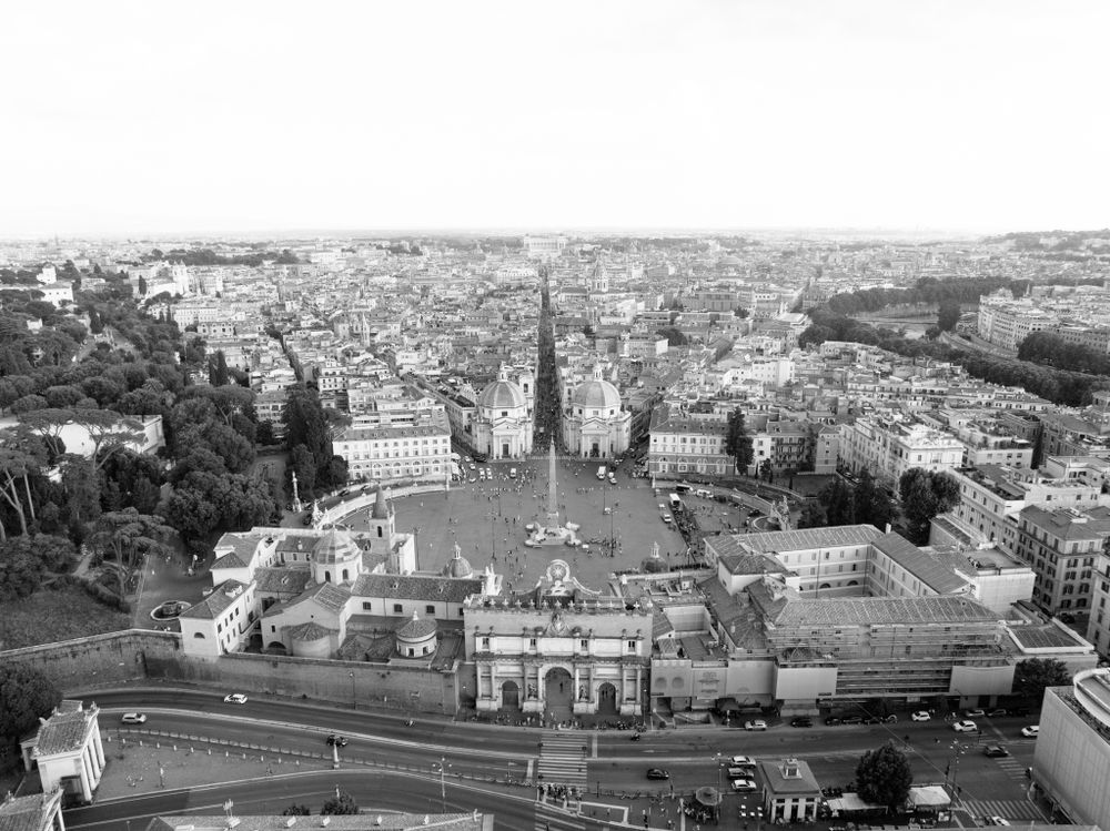 Panoramic black and white cityscape view showing historic architecture and urban landscape.