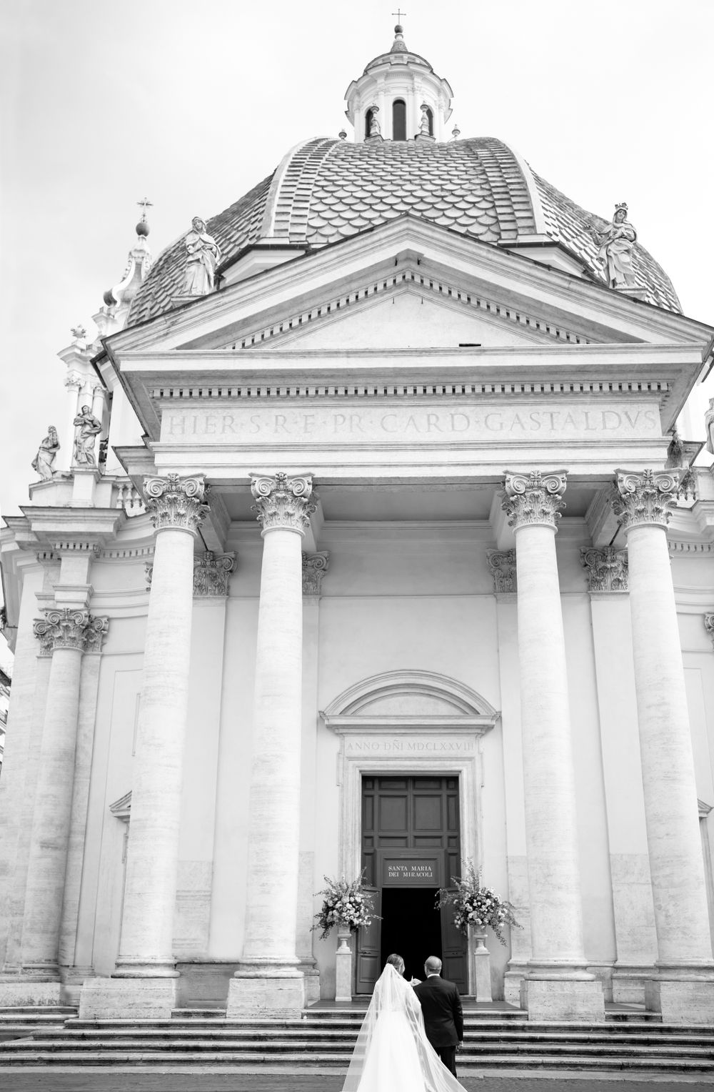 Exterior view of a grand neoclassical church with white columns and domed architecture.