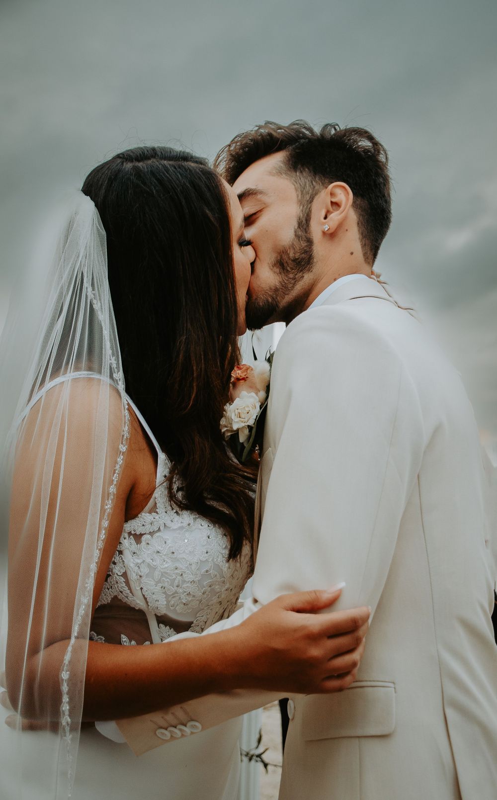 Bride and groom sharing a joyful moment on their wedding day, captured in a candid and romantic setting