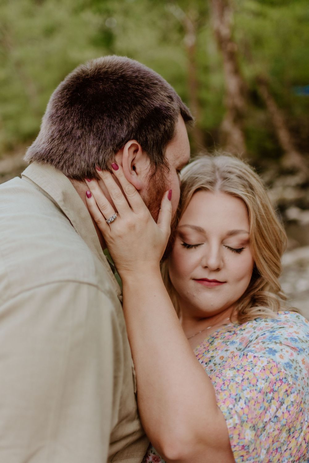 Tender outdoor portrait session with couple in floral dress and tan shirt.