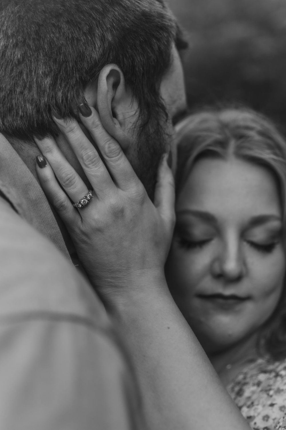 Close up black and white intimate portrait of couple sharing tender moment.