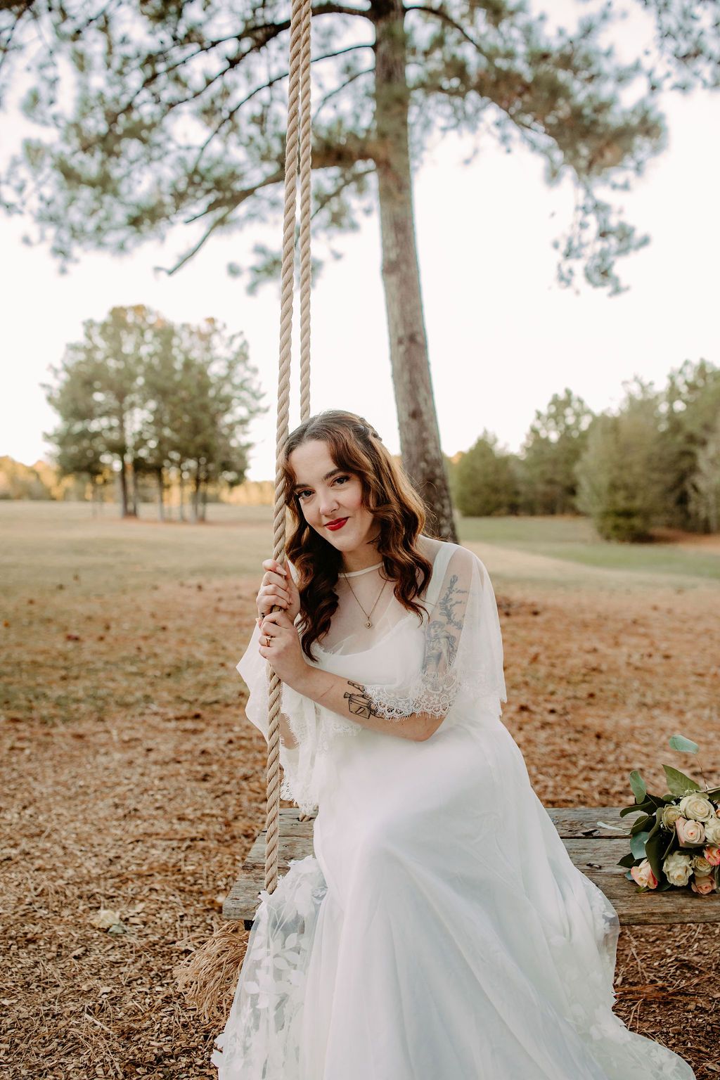 Bridal portraits on swing in tree at Sanctuaire Atelier.