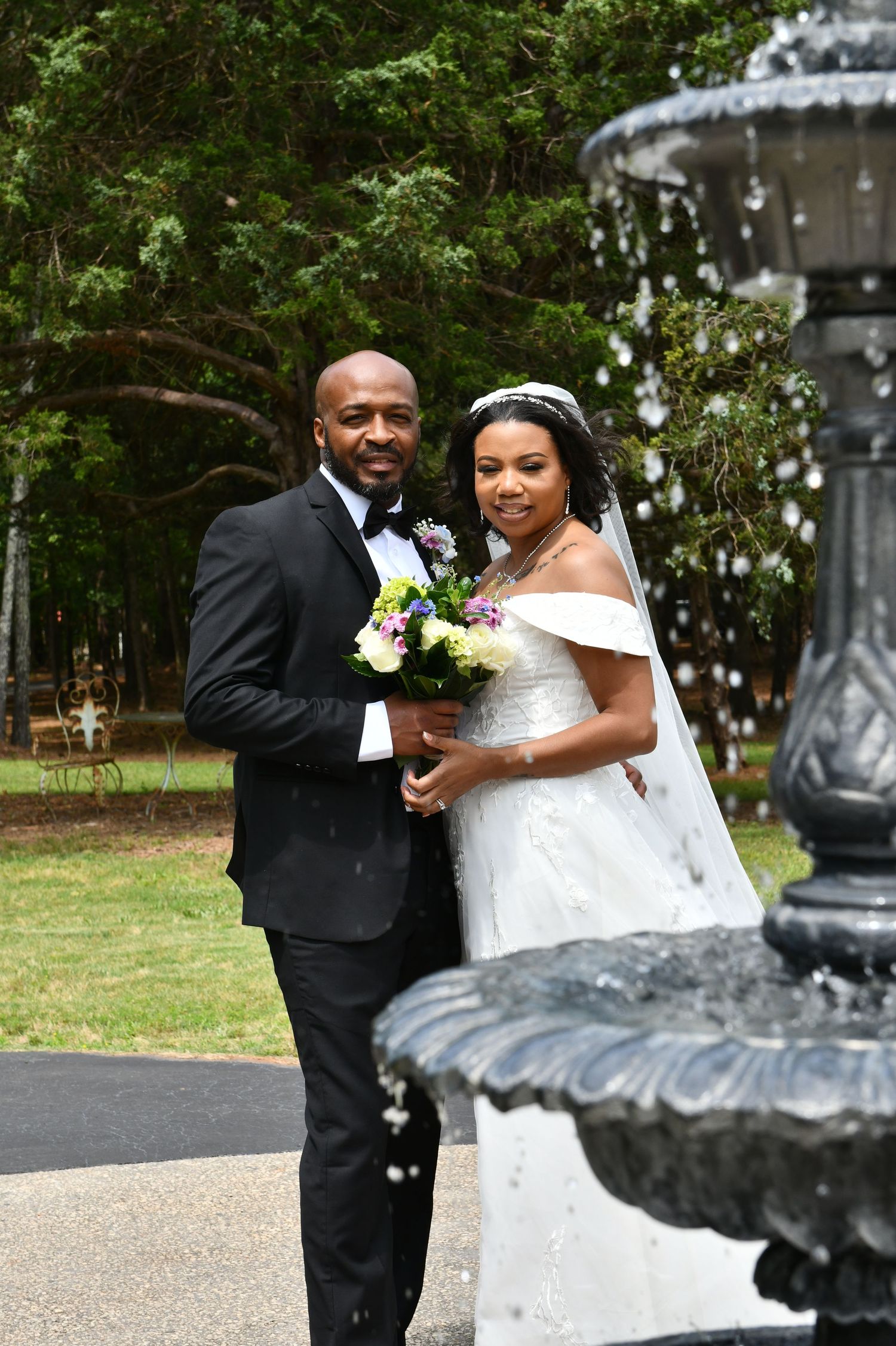 Wedding photography: Bride and Groom behind chic water fountain at Sanctuaire Atelier.