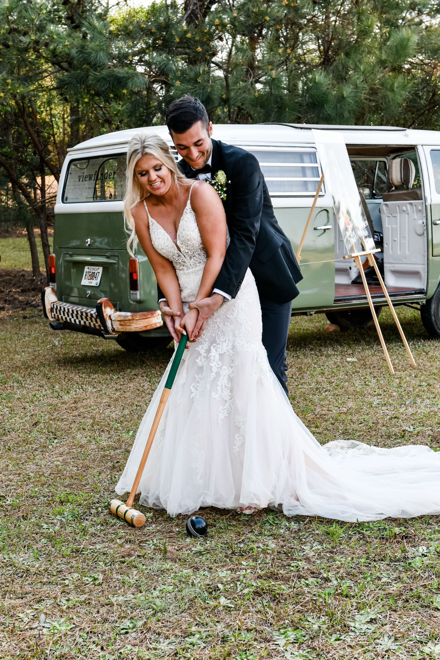 Georgia Wedding Venue: Bride and groom play a loving game of croquet in front of refurbished Volkswagen at Sanctuaire Atelier.