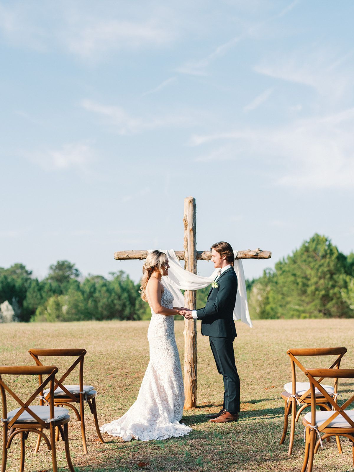 Georgia Wedding Venue- outdoor- cross- intimate- wedding dress- flowers- blue sky- private venue Sanctuaire Atelier.
