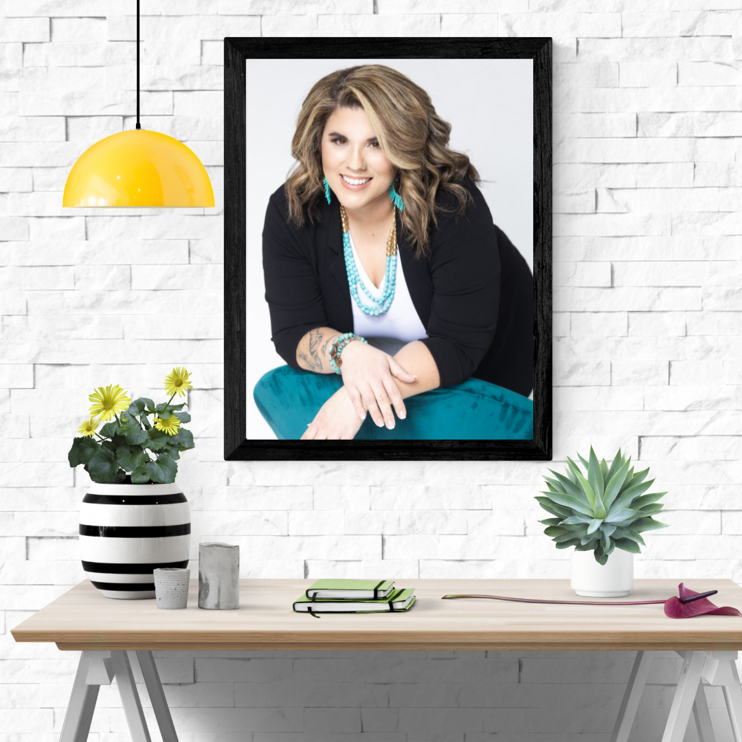 table with picture of a woman leaning on a teal chair above it
