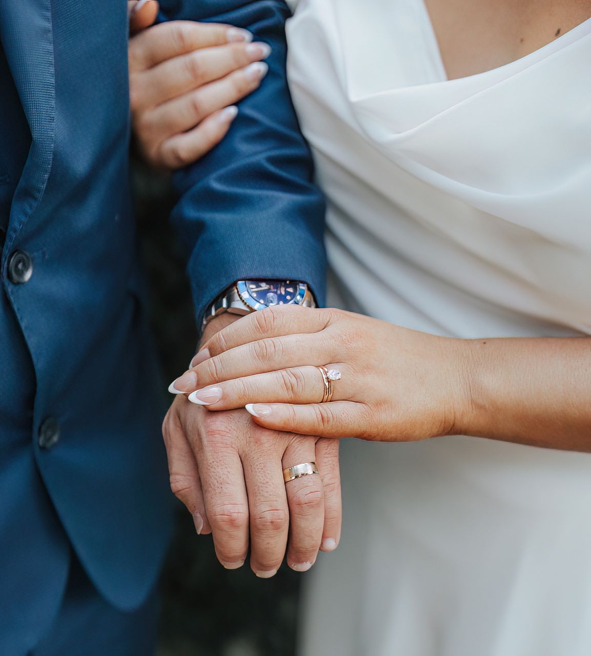 Close-up shots of hands displaying wedding rings and engagement jewelry.