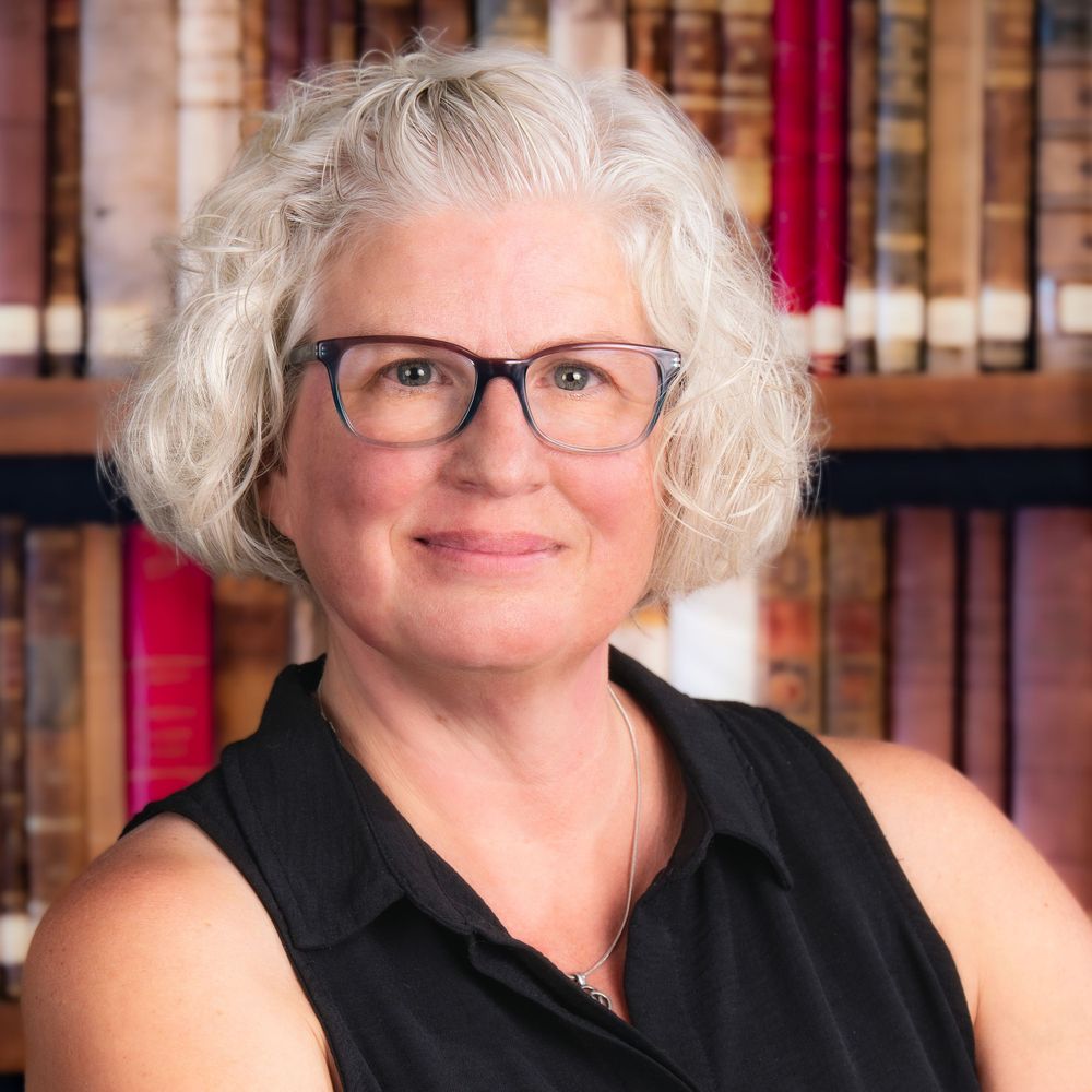 headshot with library shelf backdrop