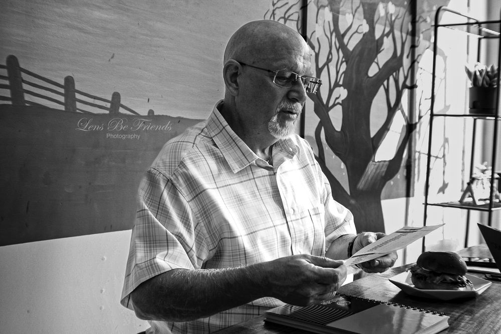 Black and white series showing silhouettes of figures reading in window light.