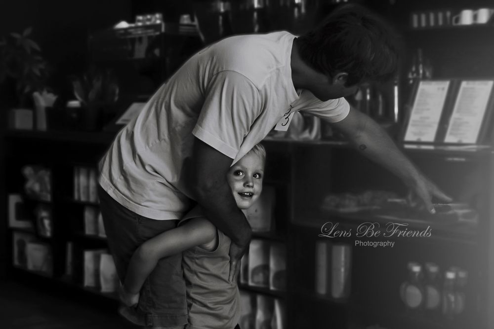 Candid black and white shots capturing movement and interaction in a dark indoor setting.