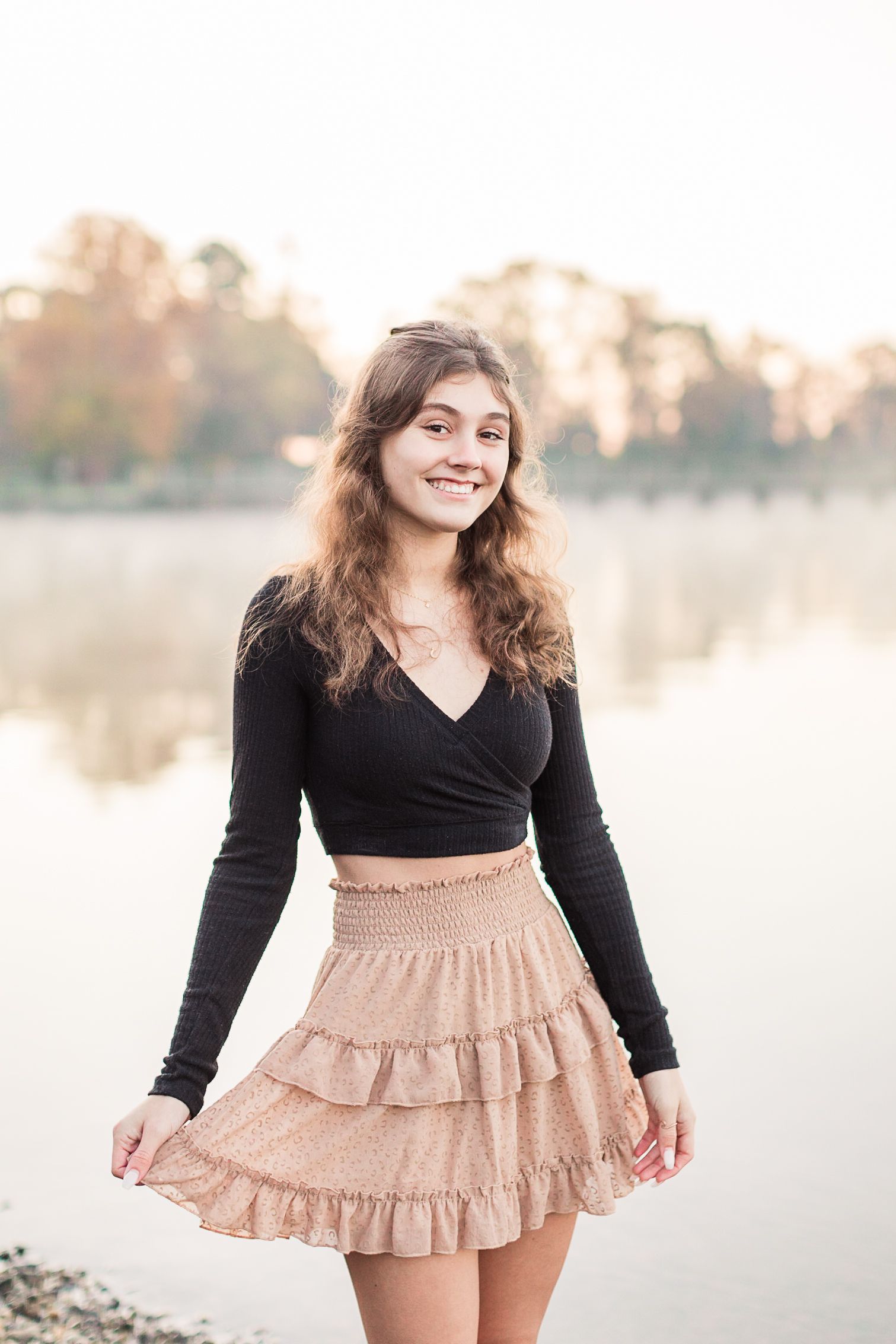 Senior girl posing with water in background